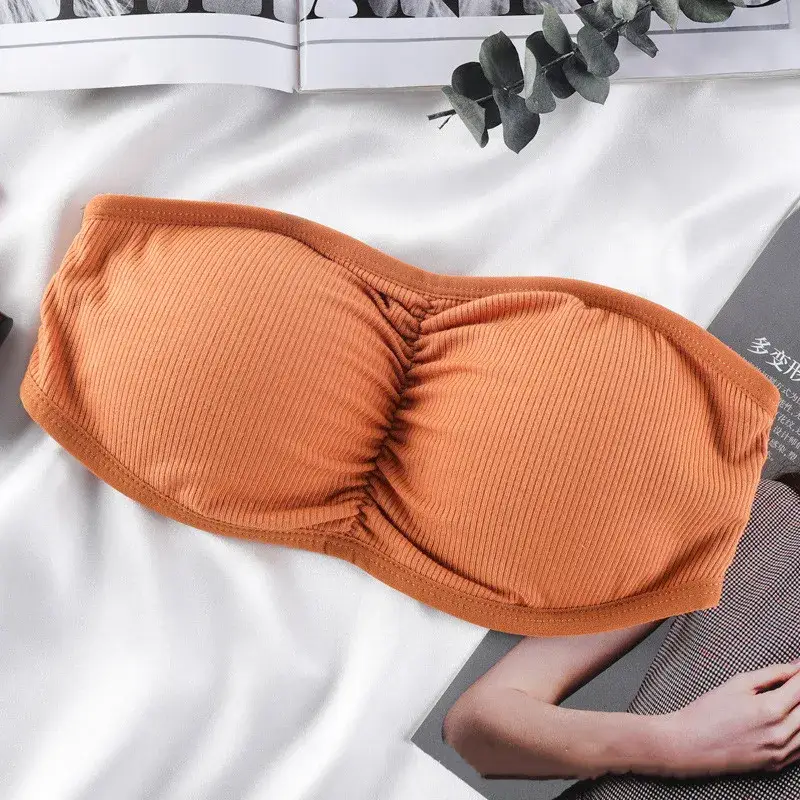 Orange strapless bra with removable straps for versatile styling.